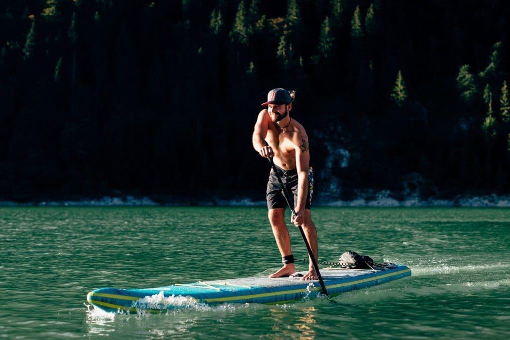Man riding an inflatable SUP board